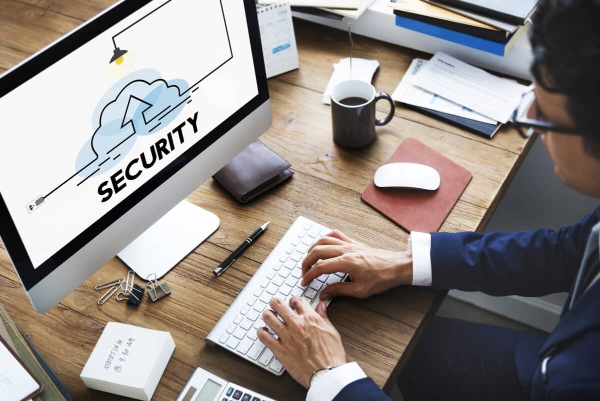 a business person works on their computer managing essential security measures
